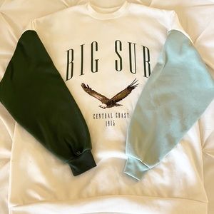 This is an Isaac Morris crew neck, that is white and green, in the size XS.